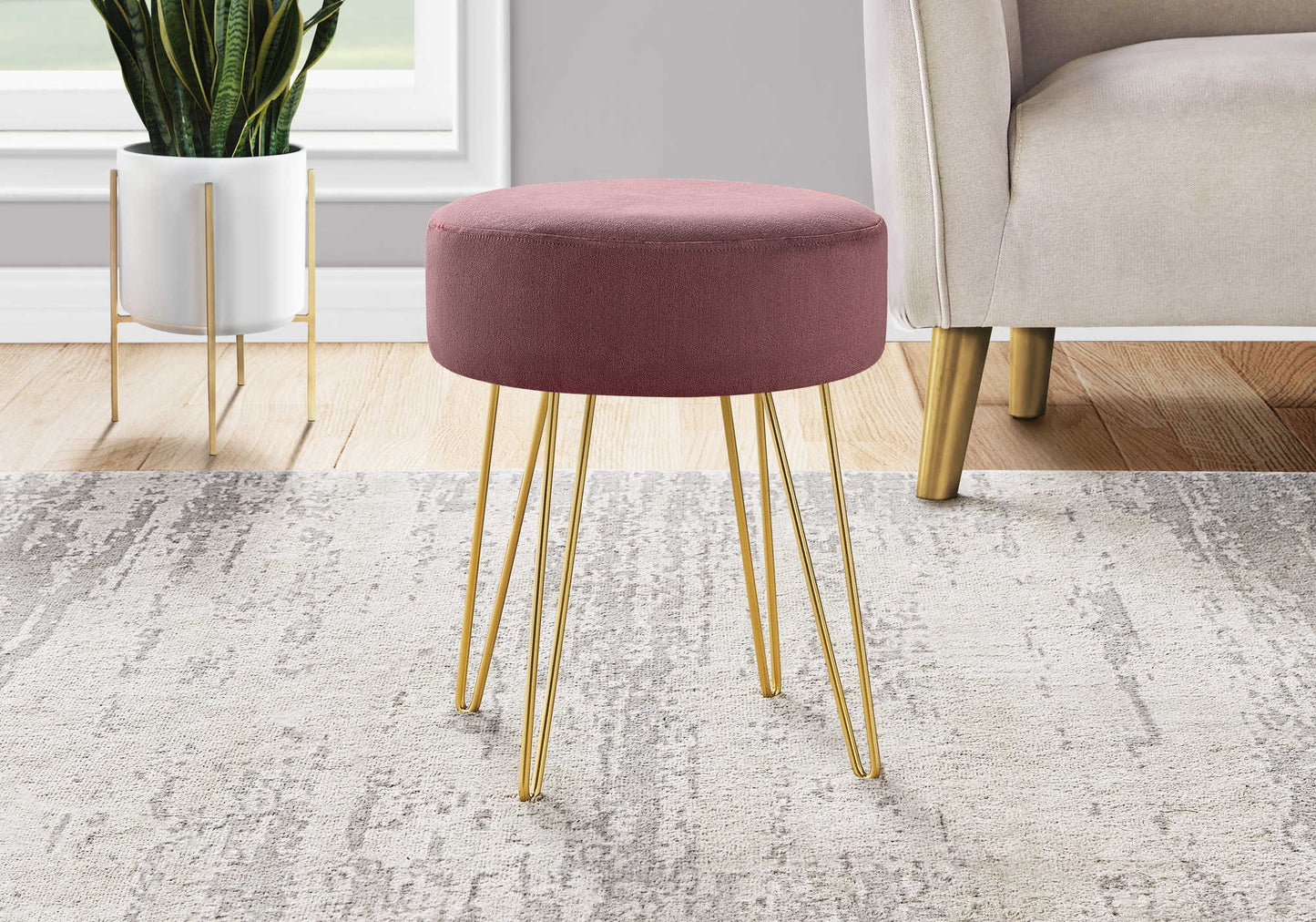 Blush pink fabric ottoman with sleek gold hairpin legs - versatile as footrest, seat, or side table