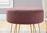 Soft pink round ottoman styled with neutral furniture in modern boho living room